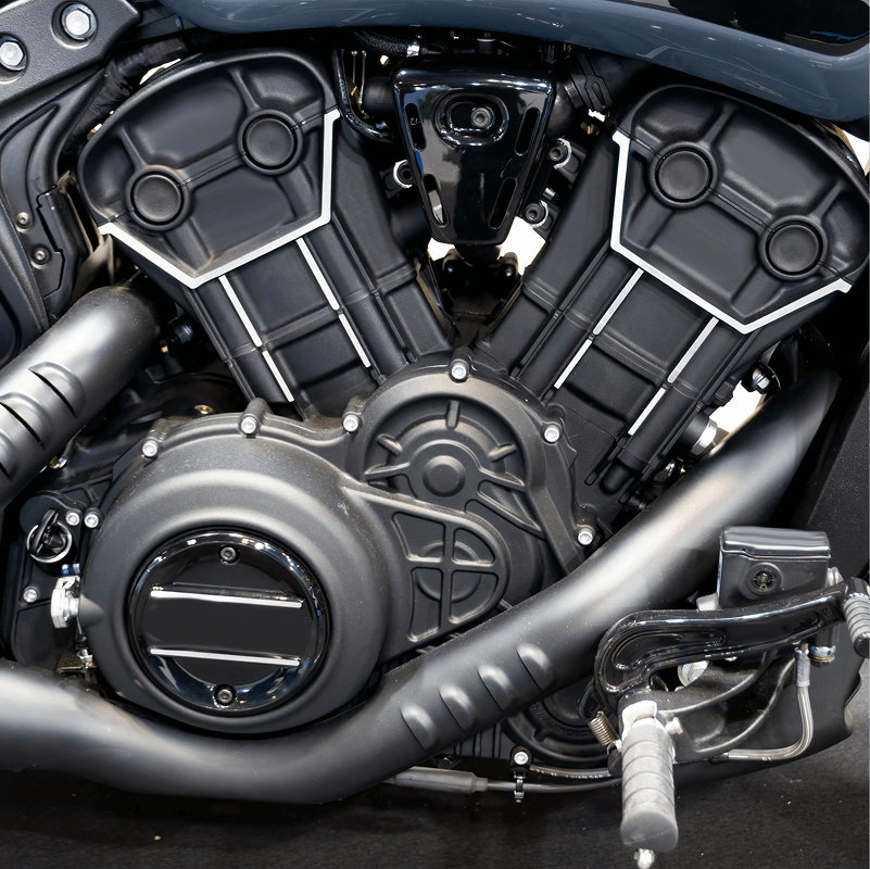 Black motorcycle engine, shiny metal parts.