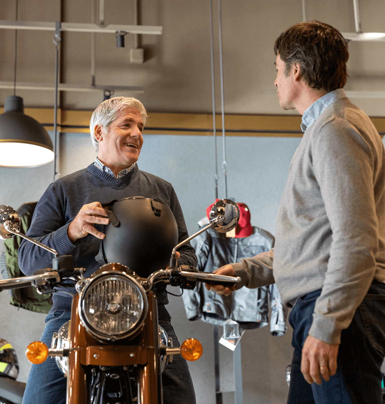 Two men talking in motorcycle shop