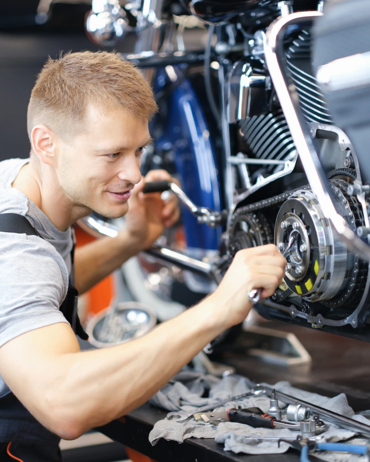 Technician adjusting motorcycle parts