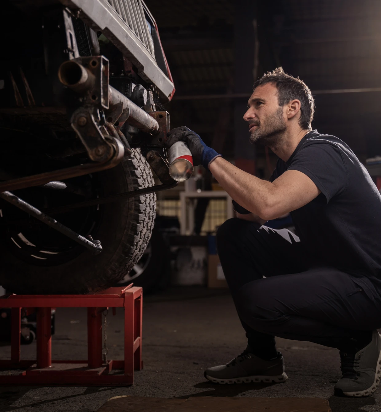 Technician inspecting vehicle exhaust system